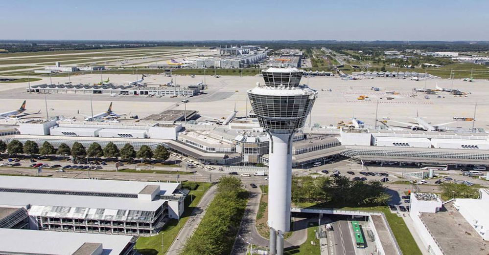 Luftaufnahme des Flughafens von München mit Blick auf Tower, Parkhäuser sowie das Terminal 1 und Vorfeld-West