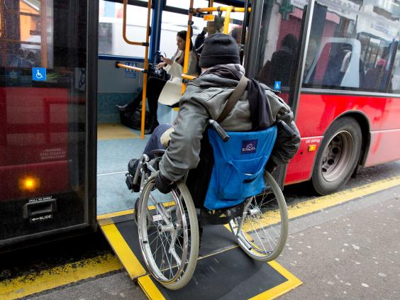 A man in a wheelchair boards a city bus via a ramp. (photo credit theasiantoday.com))